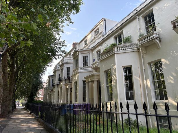 The beautiful buildings have large sash windows and tall pillars either side of the door