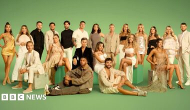 The cast of The Only Way is Essex in front of a green backdrop. Twenty-one of the cast are standing and the rest are sitting either on green seats or on the floor.