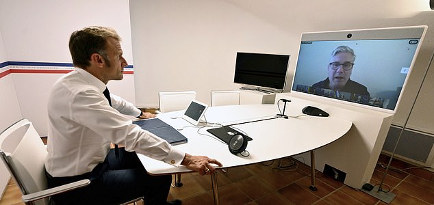 French President Emmanuel Macron listens to British Prime Minister Keir Starmer as he takes part in a video meeting of the so-called "coalition of the willing" to discuss next steps for Ukraine, Monday Aug.19, 2025 at the Fort de Bregancon in Bormes-les-Mimosas, southern France. ( Christophe Simon, Pool via AP)