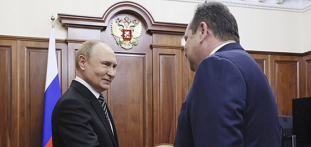 Russia President Vladimir Putin, left, shakes hands with acting Head of the Komi Republic Rostislav Goldshtein during a meeting at the Kremlin in Moscow, Russia, Tuesday, Aug. 19, 2025. (Vyacheslav Prokofyev, Sputnik, Kremlin Pool Photo via AP)