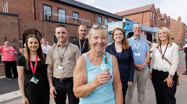Representatives from Wirral Council, Regenda, MP Alison McGovern with one of the new residents of the flats.