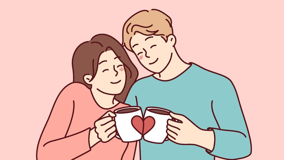 Happy couple hug drink coffee from cute cups
