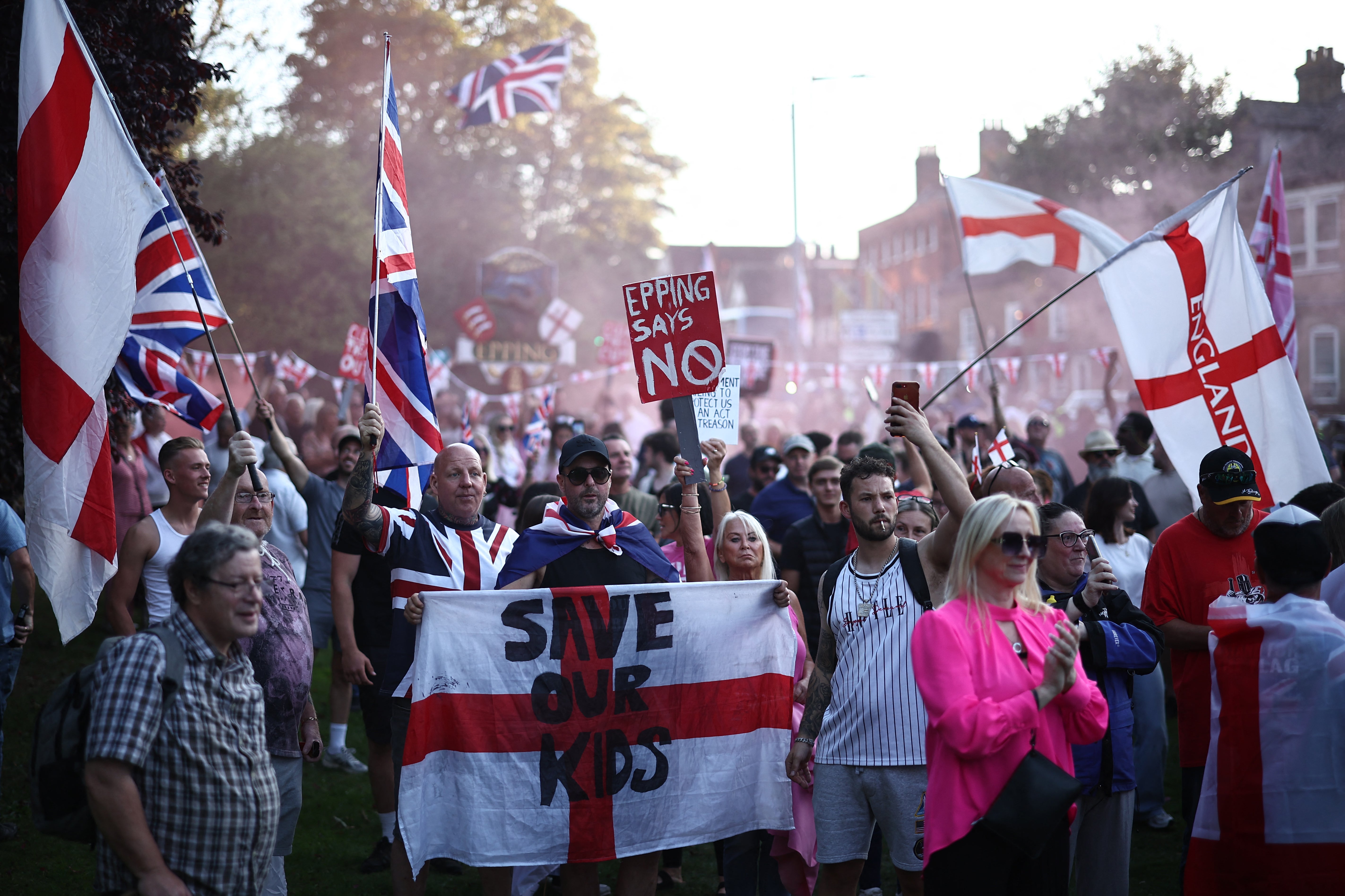 Protesters calling for the closure of the The Bell Hotel, believed to be housing asylum seekers, gather outside the council offices in Epping, northeast of London, on August 8
