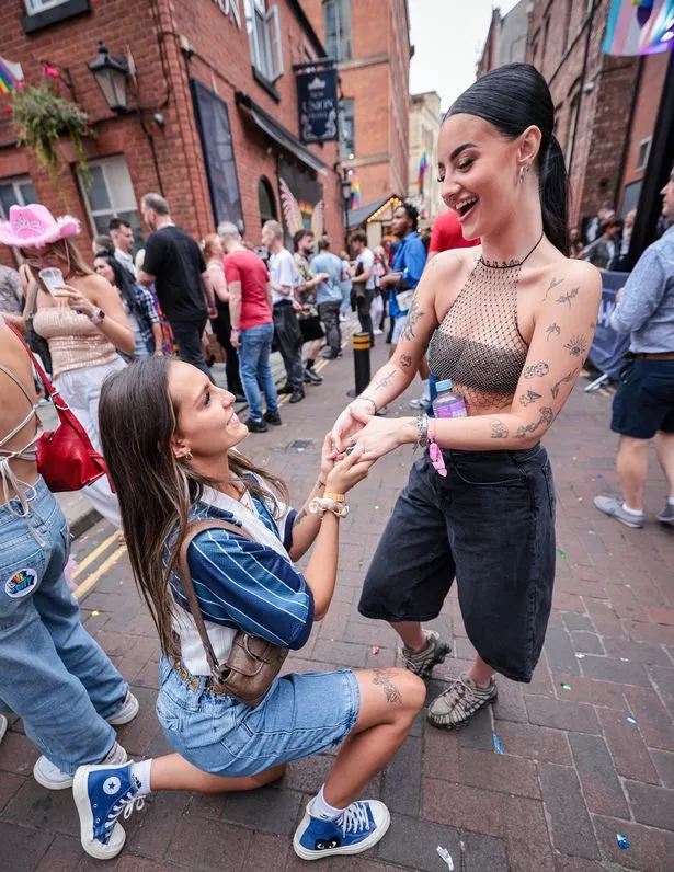 Dale proposing to her girlfriend Nicole one year after meeting at Manchester Pride