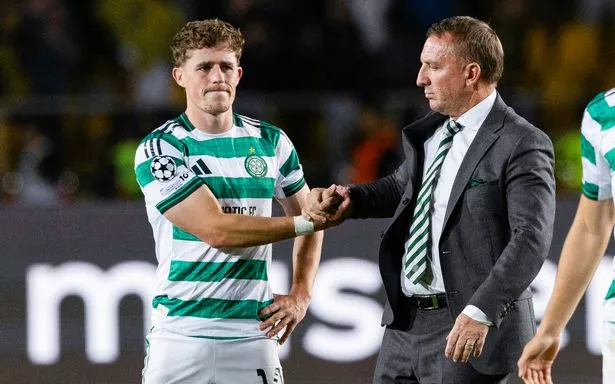 Celtic's Luke McCowan (L) and Manager Brendan Rodgers look dejected 
