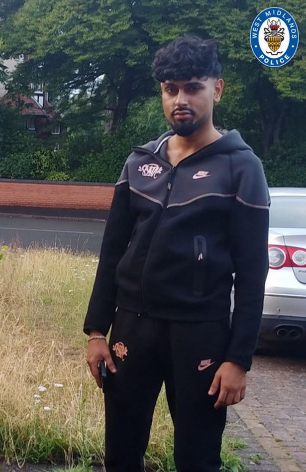 Family issued photo of Ismail Younis, 24, pictured with dark hair and a beard and wearing a black and grey Nike tracksuit 