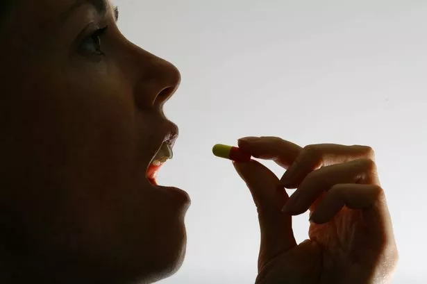 woman taking a pill