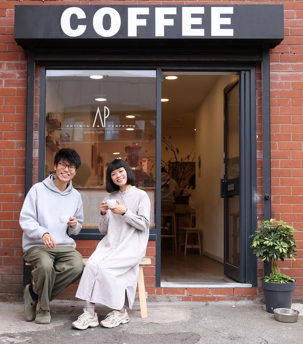 Noddy Lau with his wife Cyrus Chan outside their coffee shop 