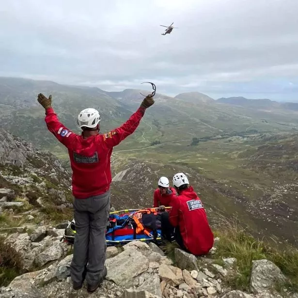An OVMRO member hails a Coastguard helicopter after a climber suffered a suspected fractured ankle in a fall on Tryfan