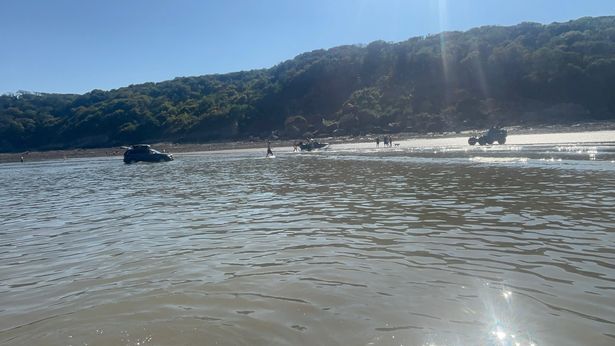 A  car stranded in the sea at Oxwich Bay