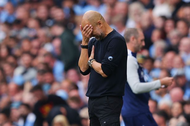 Pep Guardiola puts his head in his hand