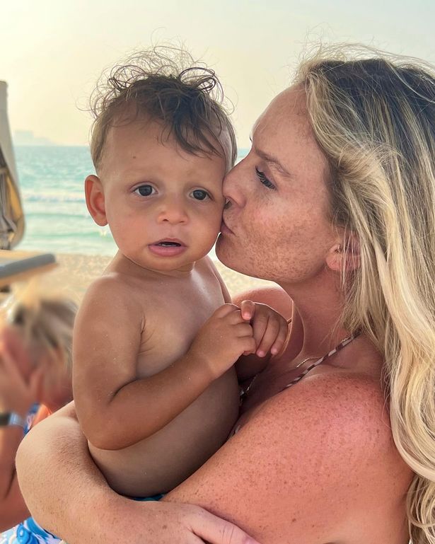 Perrie Edwards kissing her son Axel on the cheek at the beach