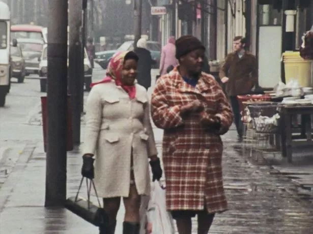 Two women walk down a South Manchester Street. December 21, 1973