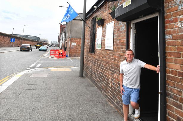 Mark Murphy from Murphy's Distillery, stands outside his bar, near the Hill Dickinson Stadium