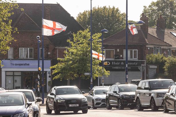 St George’s and Union Jack flags tied to lampposts around Weoley Castle
