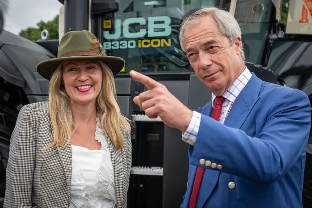 Laura Anne Jones next to Nigel Farage in front of a tractor