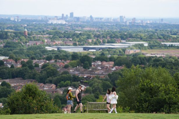 A family walk through Lickey Hills Country Park, overlooking Birmingham. Picture date: Sunday July 21, 2024. PA Photo. See PA story WEATHER July. Photo credit should read: Jacob King/PA Wire