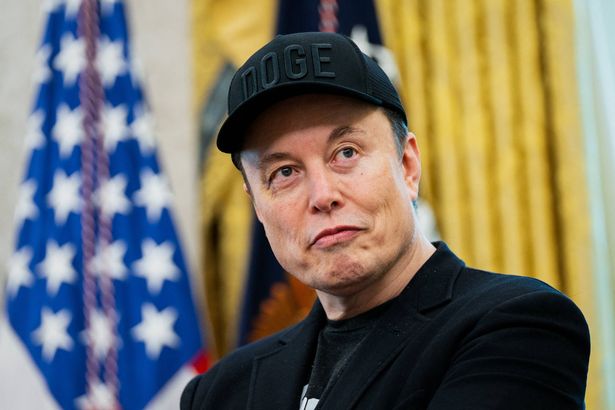 Elon Musk looks on during a news conference with US President Donald Trump in the Oval Office of the White House in Washington, DC, on May 30, 2025. Musk, who stormed into US politics as President Trump's chainsaw-brandishing sidekick, announced on May 28 that he is leaving his role in US government, intended to reduce federal spending, shortly after his first major break with the President over Trump's signature spending bill. (Photo by Allison ROBBERT / AFP) (Photo by ALLISON ROBBERT/AFP via Getty Images)          