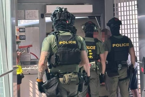 Armed police arrive at the gate