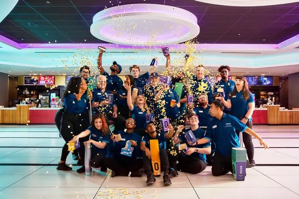 Cinema workers throwing popcorn in the air in celebration of the opening
