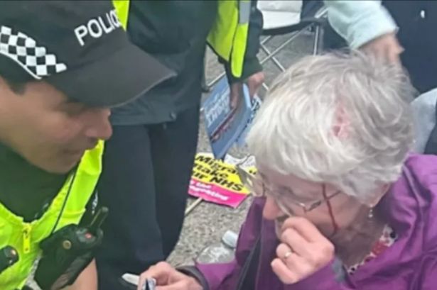 The woman was surrounded by officers after being injured during the protest