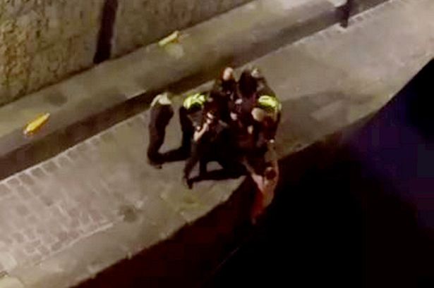 Officers pull the naked man out of the canal