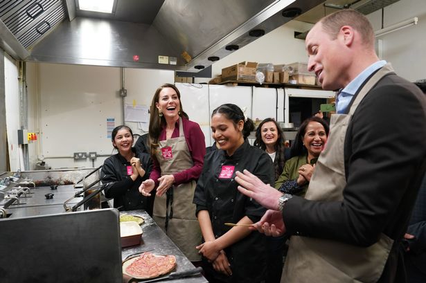 Kate and William in aprons with staff in a Birmingham kitchen