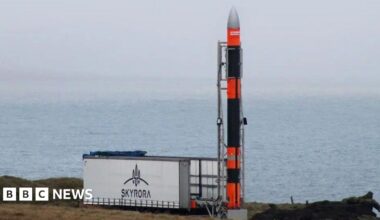 Rocket next to a Skyrora sign, with sea in the background.