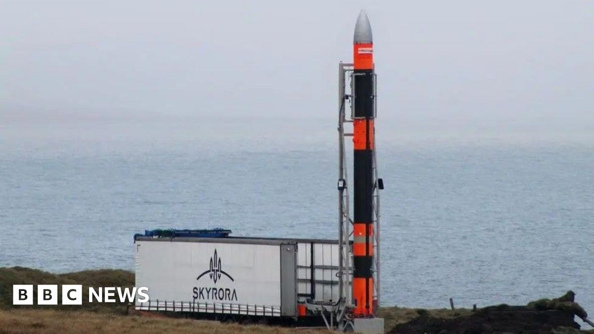 Rocket next to a Skyrora sign, with sea in the background.