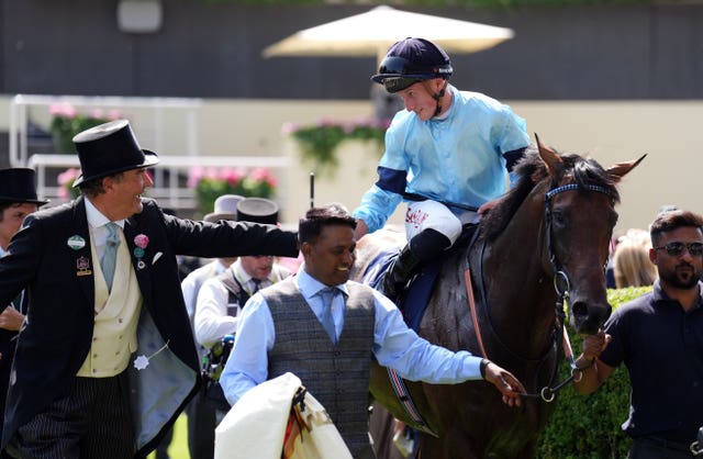Tom Marquand aboard Merchant shakes hands with Harry Herbert at Royal Ascot