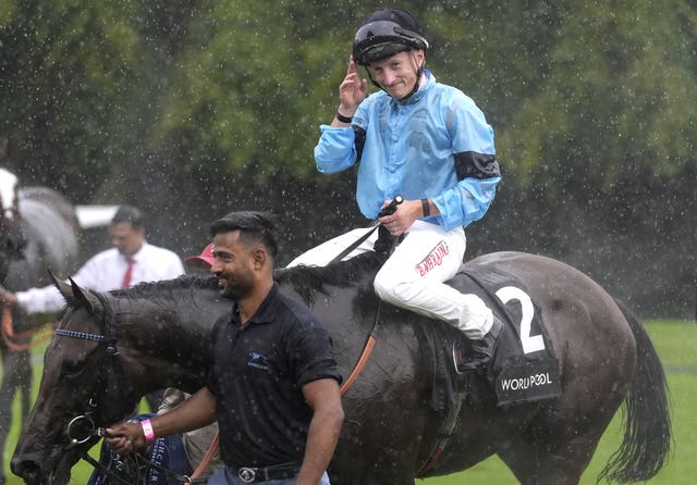 Jockey Tom Marquand celebrates after winning aboard Merchant