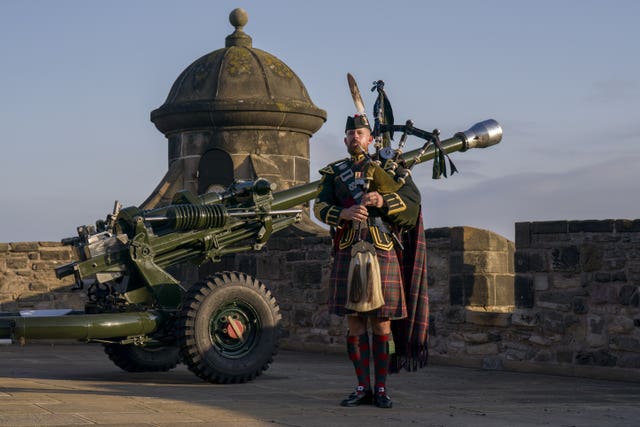 Warrant Officer Class 1, Senior Pipe Major Peter Grant plays at dawn at Edinburgh Castle