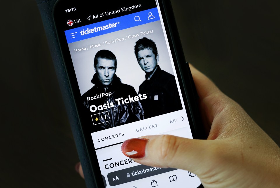 Person using Ticketmaster app to view Oasis concert tickets.