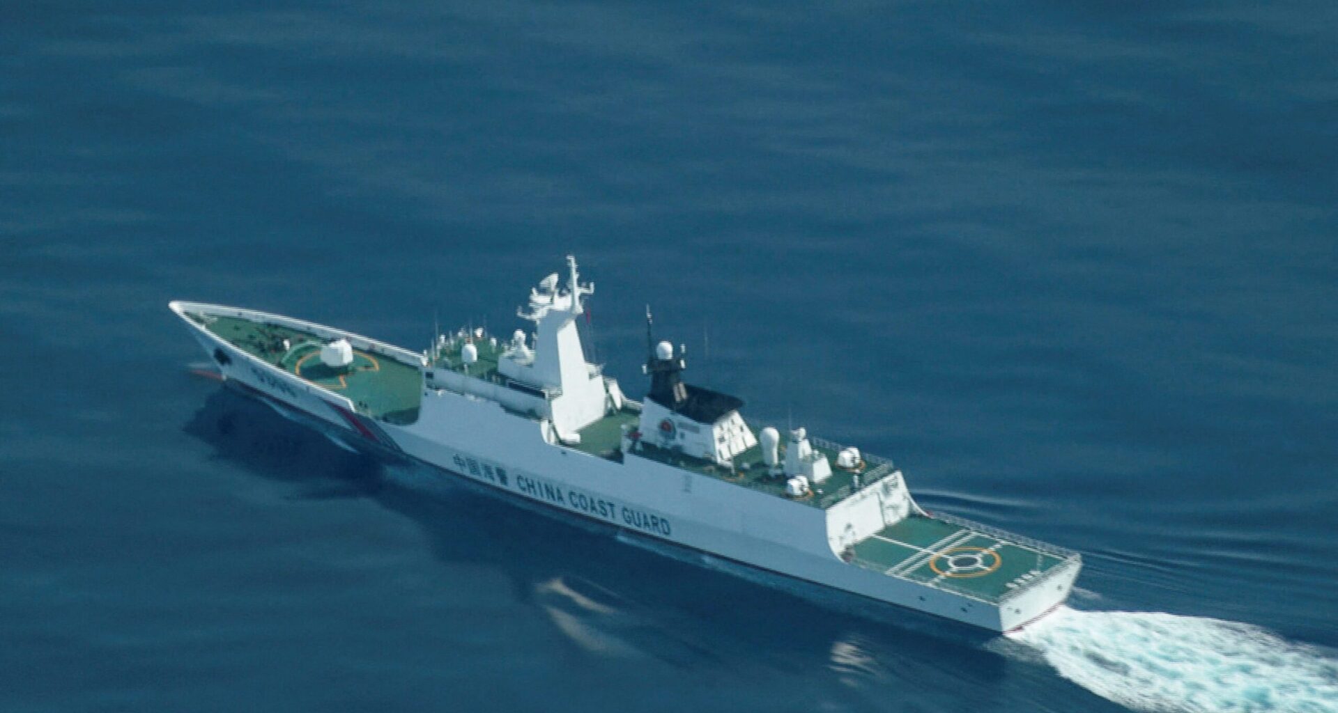 An aerial view of a China Coast Guard ship navigating near the disputed Scarborough Shoal, as Philippine Coast Guard aircraft carrying journalists patrols the area