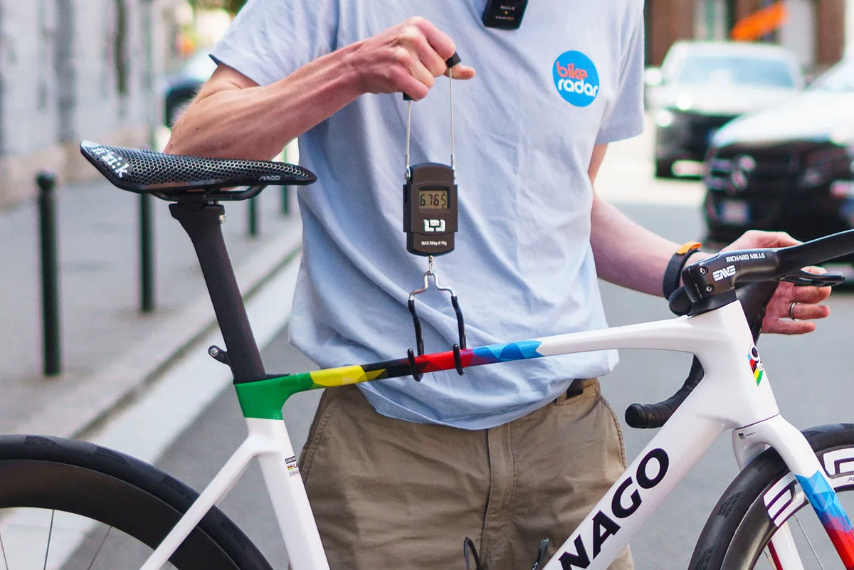 Simon von Bromley weighing Tadej Pogačar's Colnago V5Rs at the 2025 Tour de France