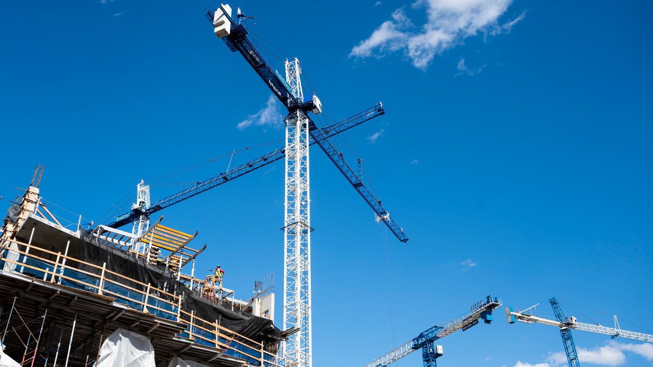 Cranes stand above a building construction site in the NOMA neighborhood of Washington