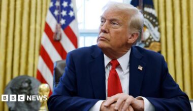 Donald Trump sits in Oval Office.