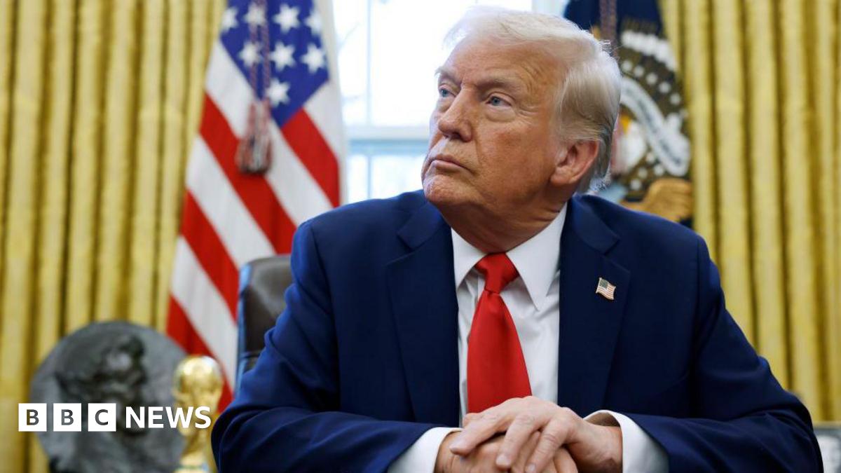 Donald Trump sits in Oval Office.