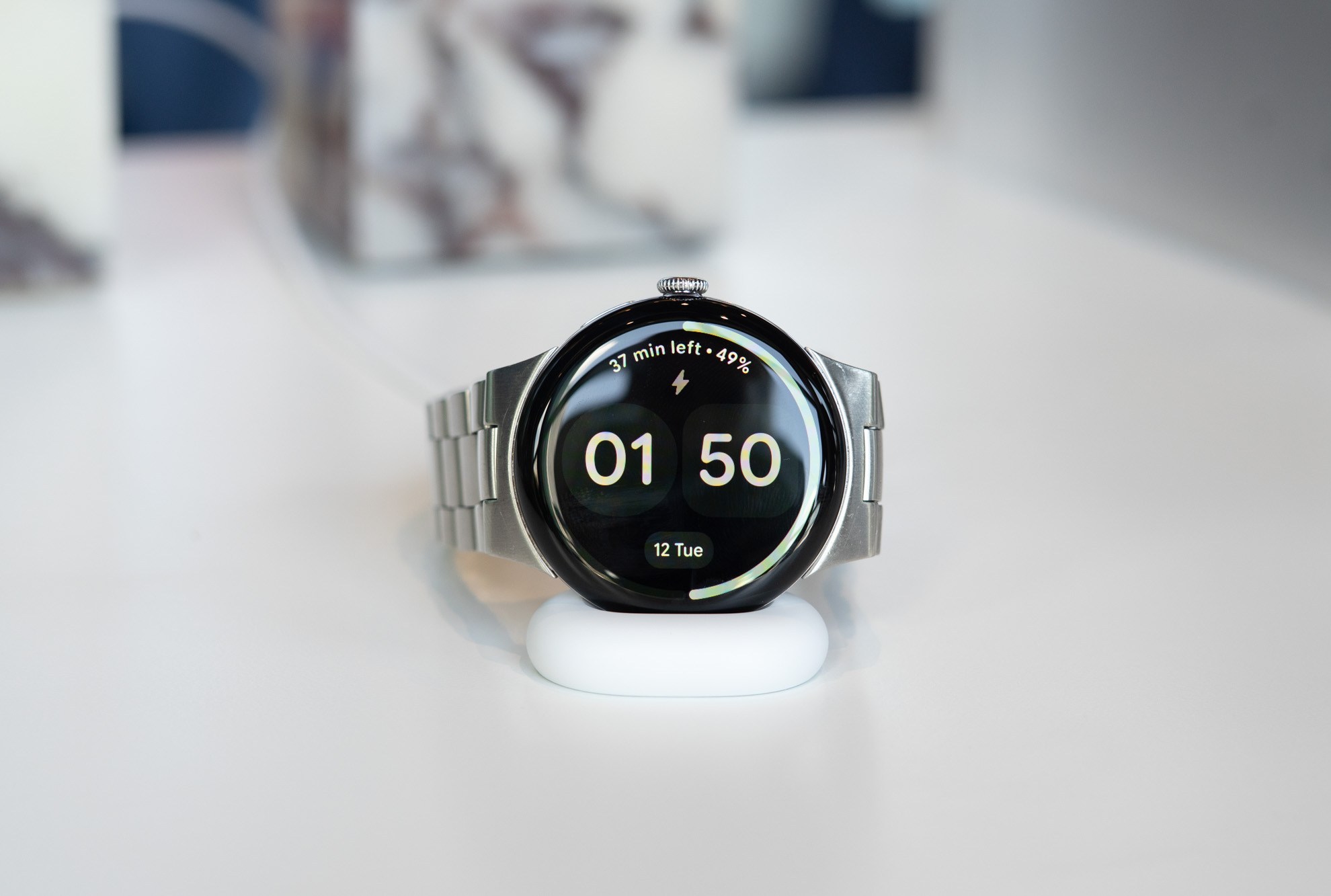 Google Pixel Watch 4 shown on charger.