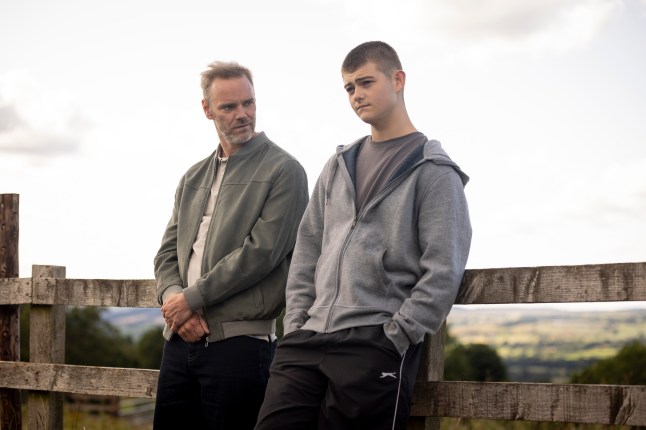 Ray Walters stands beside Dylan Penders in the village