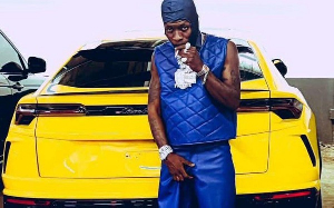 Shatta Wale in a pose with his Lamborghini Urus