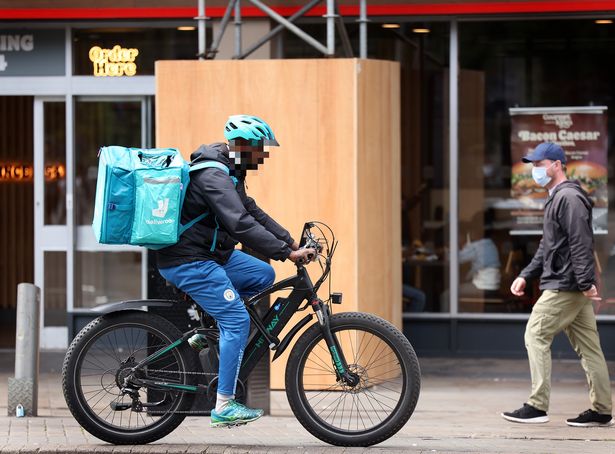 A Deliveroo rider on an e-bike
