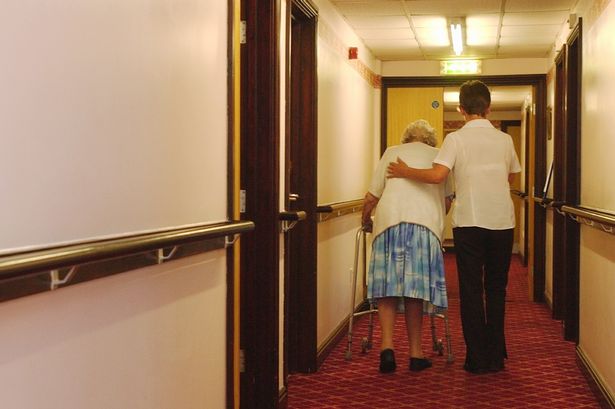 NEWS - ELDERLY CARE GENERICS  Generic images shows a care assistant helping an elderly female along a residential home corridor.  POST PHOTO C270705DL4-03  Dominic Lipinski