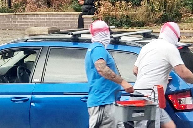 The two men wearing St George's masks were captured on camera 