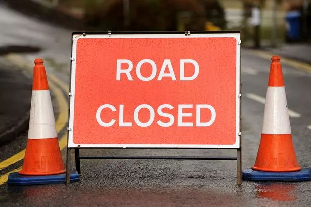 General view of a 'Road Closed' sign warning sign.
