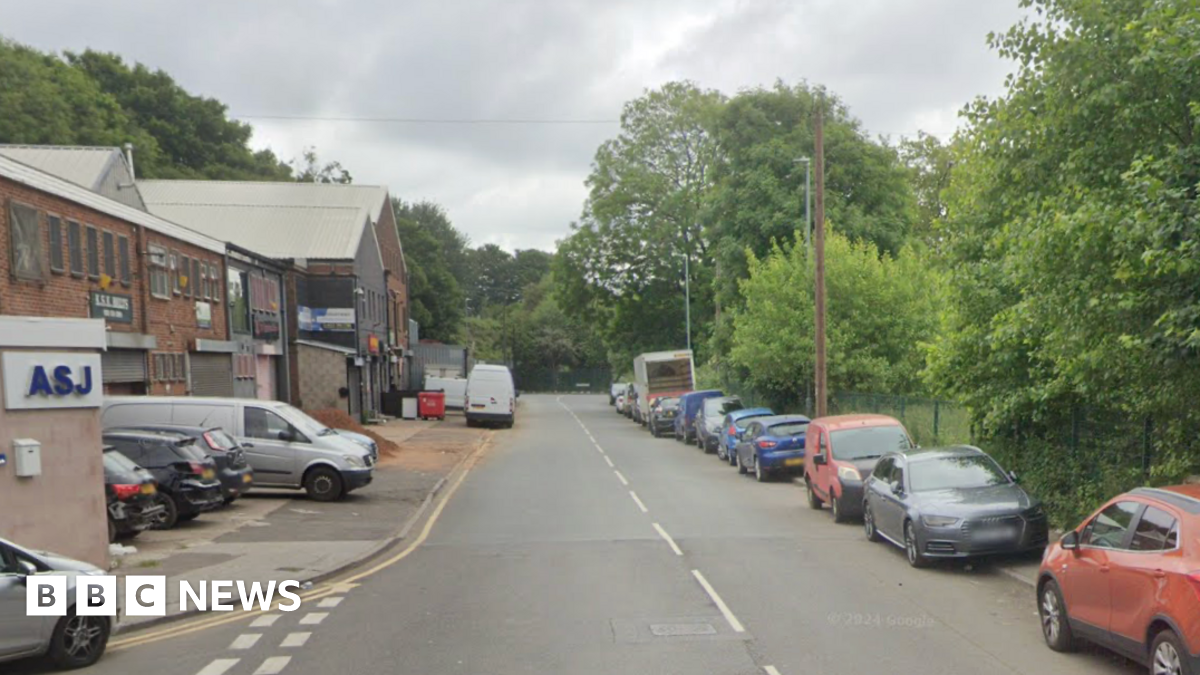 A google street view imagine of a road on an industrial estate with cars parked on the right hand side kerb
