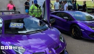 Two purple Lamborghinis, each with a sign that reads: "Seized by Police" on the windscreen.