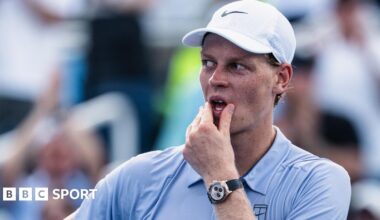 Jannik Sinner watches on