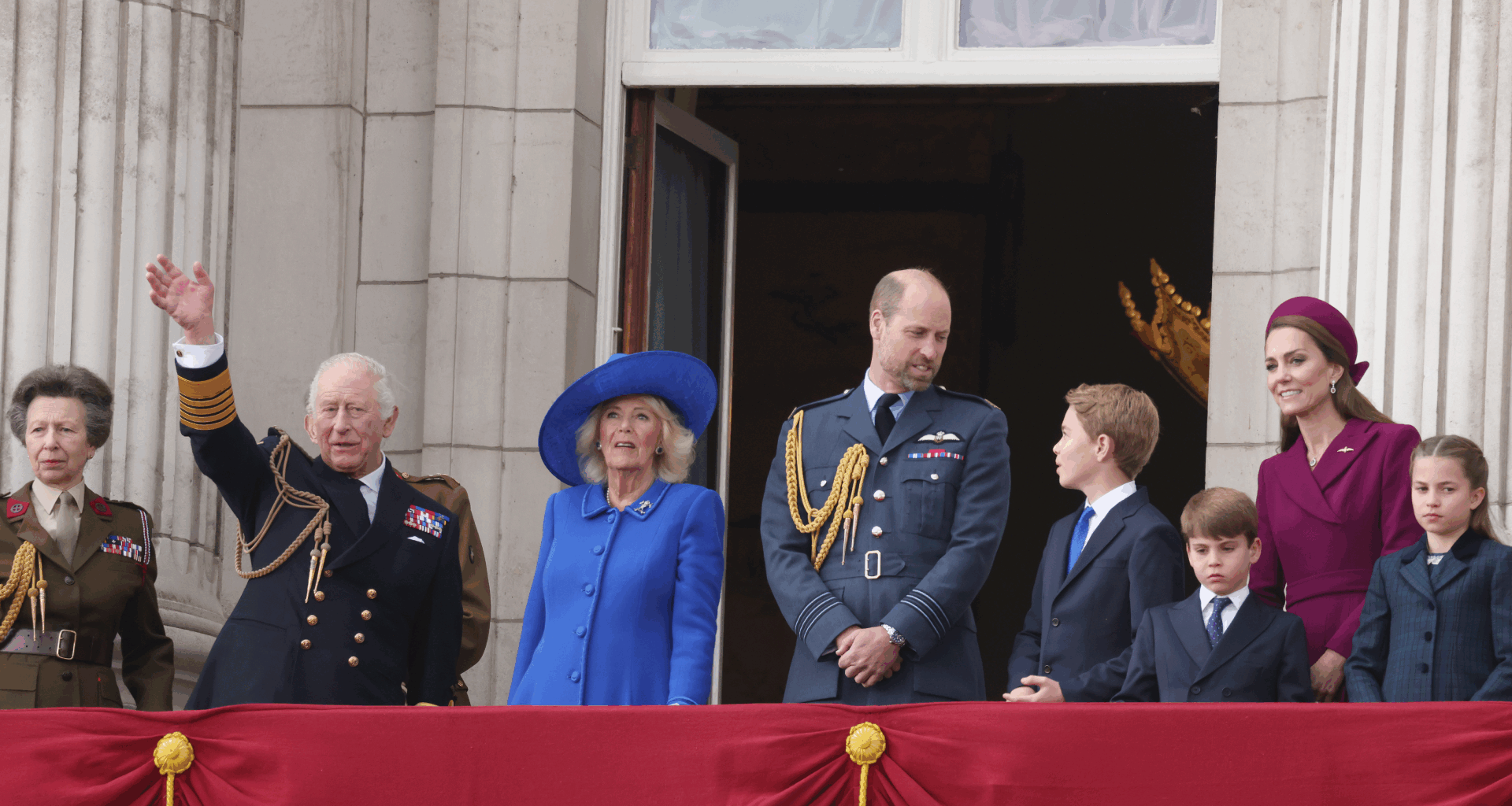 Queen Camilla, Prince William, Princess Kate, Prince George, Prince Louis and Princess Charlotte standing on the balcony of Buckingham Palace