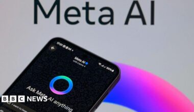 A black smartphone displaying Meta AI is shown next to a background of a post for Meta AI